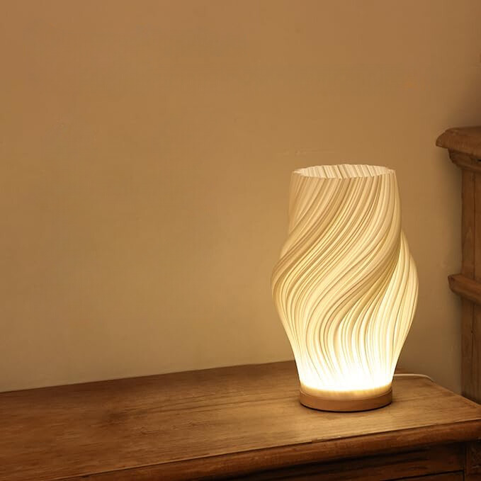 Tischleuchte mit Wellendesign und LED-Licht -    Zorenza